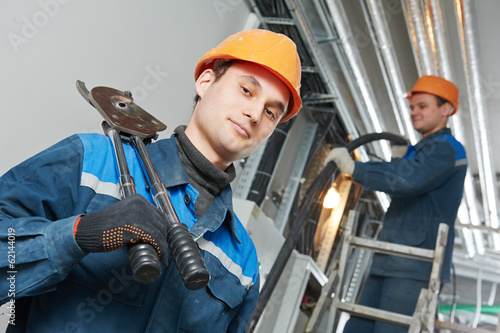 Photo: two electrician worker at cabling two electrician worker at cabling