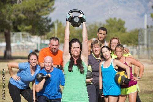 Photo: Woman Struggling with Weights Woman Struggling with Weights
