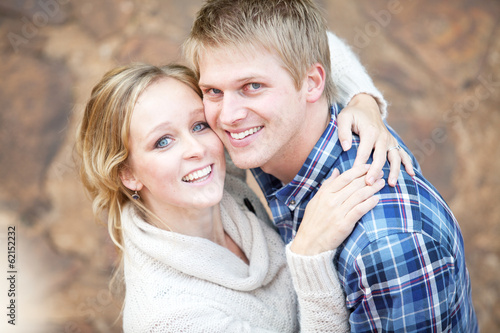 Photo: Young couple in love looking up at viewer Young couple in love looking up at viewer