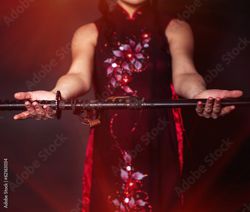 Photo: Woman with japan sword katana in hands Woman with japan sword katana in hands