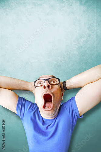 Photo: amazed man stunned ligh blue background amazed man stunned ligh blue background