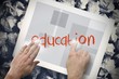 Hand touching education on search bar on tablet screen Hand touching education on search bar on tablet screen