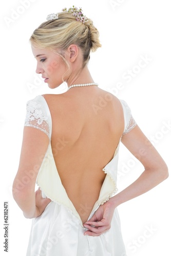 Photo: Rear view of beautiful bride wearing wedding dress Rear view of beautiful bride wearing wedding dress