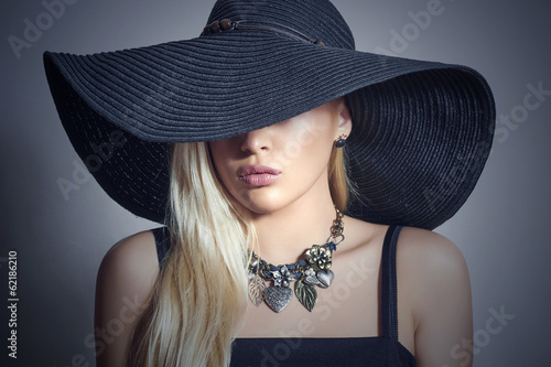 Photo: Beautiful Blond Woman in Black Hat.Accessories.Lady in Jewelry Beautiful Blond Woman in Black Hat.Accessories.Lady in Jewelry