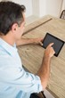 Concentrated man using digital table at home Concentrated man using digital table at home