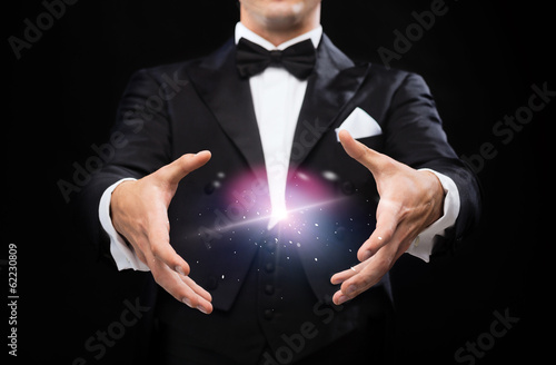 Photo: magician in top hat showing trick magician in top hat showing trick