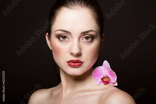 Photo: Beautiful woman with orchid Beautiful woman with orchid