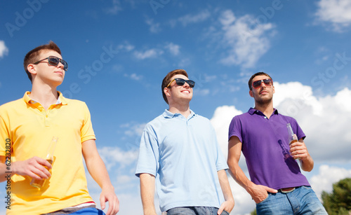 Photo: group of male friends with bottles of beer group of male friends with bottles of beer