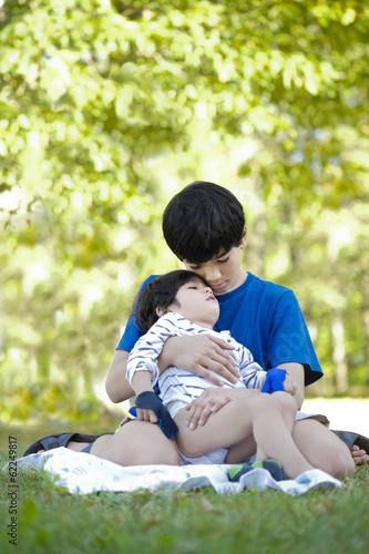 Photo: Older brother comforting little boy Older brother comforting little boy