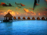 houses over the transparent quiet sea water on a sunset