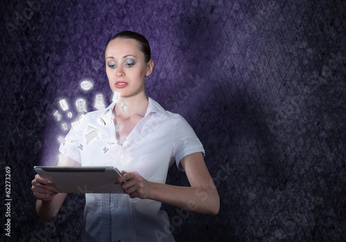 Photo: young attractive woman holding a tablet young attractive woman holding a tablet