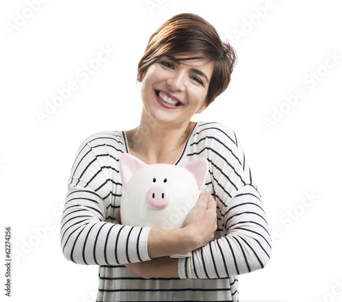 Photo: Beautiful happy woman with a piggybank Beautiful happy woman with a piggybank