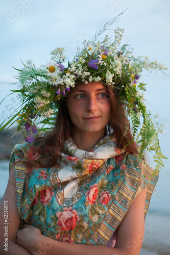 Photo: Beautiful Girl with summer bouquet and wreath of grass. Beautiful Girl with summer bouquet and wreath of grass.