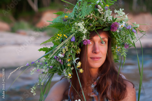 Photo: Beautiful Girl with summer bouquet and wreath of grass. Beautiful Girl with summer bouquet and wreath of grass.