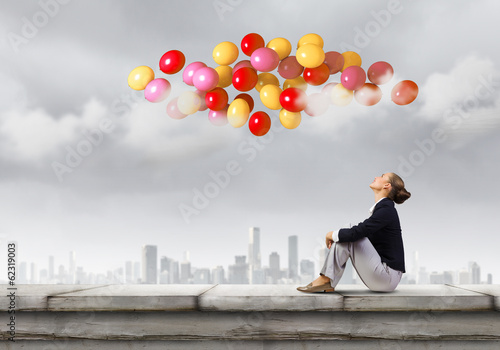 Photo: Businesswoman on roof Businesswoman on roof