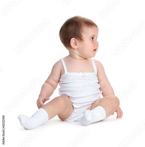 Photo: Cute baby girl sitting isolated on white Cute baby girl sitting isolated on white