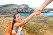 Helping hand - hiker woman getting help on hike Helping hand - hiker woman getting help on hike