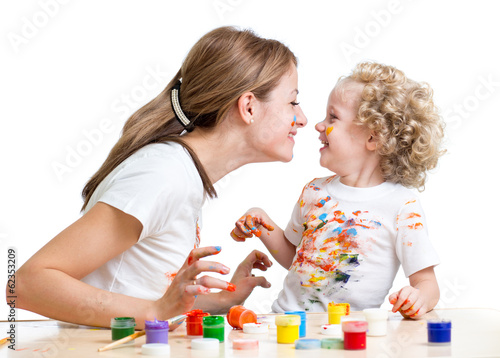 Photo: smiling mother and child girl painting together smiling mother and child girl painting together