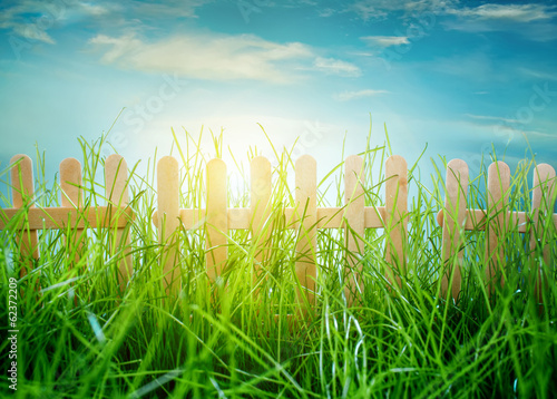 Photo: Wooden fence on blue sky background Wooden fence on blue sky background