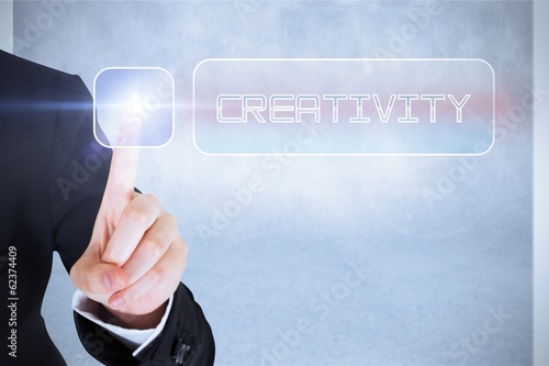 Photo: Businesswomans finger touching Creativity button Businesswomans finger touching Creativity button