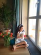 beautiful little girl sits near window beautiful little girl sits near window
