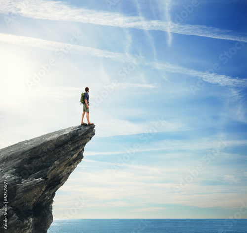 Photo: Young man standing on a peak Young man standing on a peak