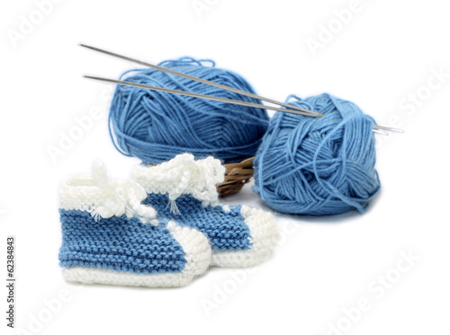 Photo: Funny boys' booties with yarn, isolated on white Funny boys' booties with yarn, isolated on white