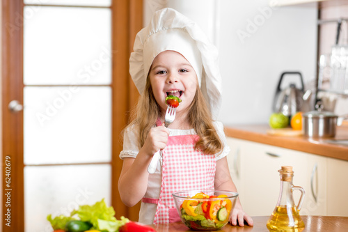 Photo: Chef kid tasting healthy food Chef kid tasting healthy food