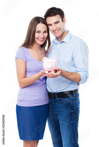Photo: Young couple holding piggy bank Young couple holding piggy bank