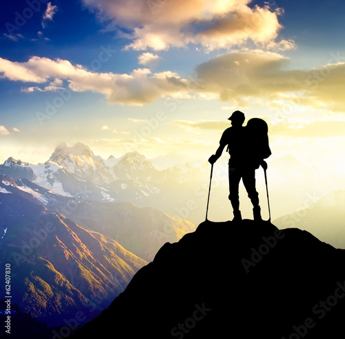 Photo: Sillhouette of a tourist on the high mountain. Sillhouette of a tourist on the high mountain.