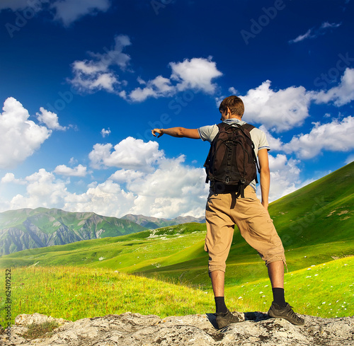 Photo: Tourist on mountain peak. Sport and active life Tourist on mountain peak. Sport and active life