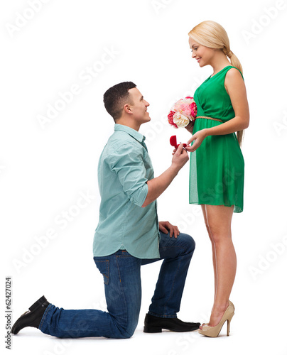 Photo: smiling couple with flower bouquet and ring smiling couple with flower bouquet and ring