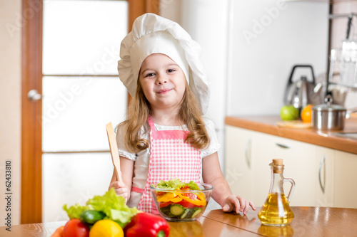 Photo: kid girl preparing healthy food vegetable salad kid girl preparing healthy food vegetable salad