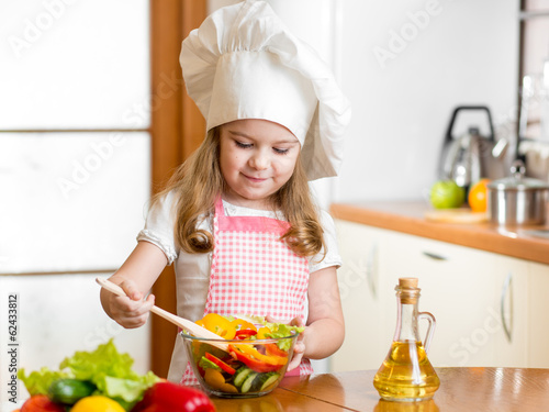 Photo: kid making salad at kitchen kid making salad at kitchen