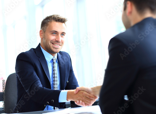 Photo: Business people shaking hands, finishing up a meeting Business people shaking hands, finishing up a meeting