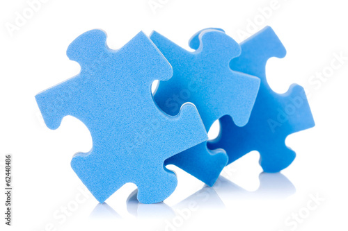 Photo: Three puzzle pieces on white Three puzzle pieces on white