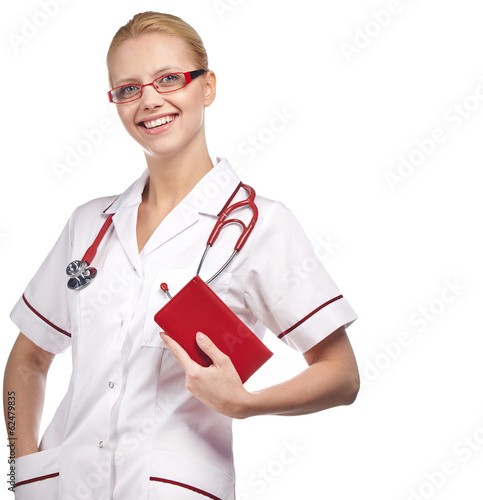 Photo: Close-up portrait of a female doctor smiling with arms crossed. Close-up portrait of a female doctor smiling with arms crossed.