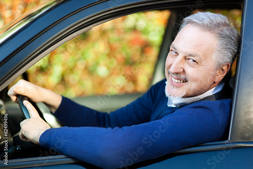 Photo: Mature man driving his car Mature man driving his car