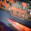Venice, a wooden boat in a canal Venice, a wooden boat in a canal