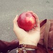 holding juisy apple holding juisy apple