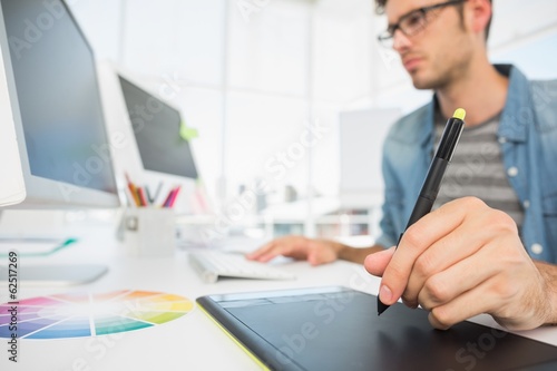 Photo: Casual male photo editor using graphics tablet Casual male photo editor using graphics tablet