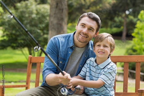 Photo: Father and son fishing on park bench Father and son fishing on park bench