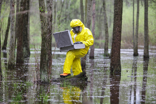 Photo: professional with mini lab in contaminated environment professional with mini lab in contaminated environment