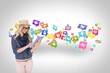 Stylish blonde using tablet pc with app icons Stylish blonde using tablet pc with app icons