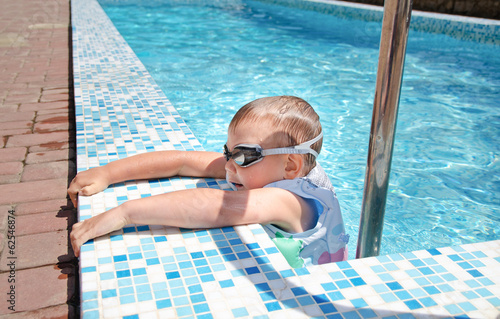Photo: Small boy clambering out swimming pool Small boy clambering out swimming pool