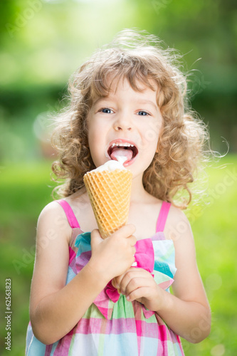 Photo: Happy child eating ice cream Happy child eating ice cream
