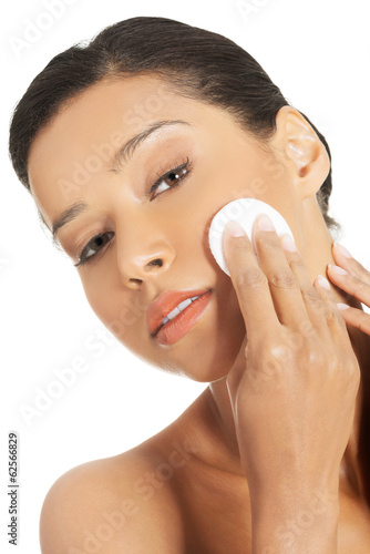 Photo: Beautiful woman with cosmetic pad. Beautiful woman with cosmetic pad.