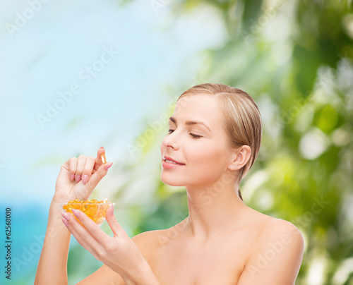 Photo: lovely woman with omega 3 vitamins lovely woman with omega 3 vitamins