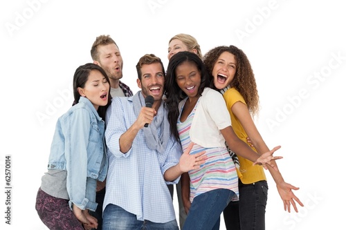 Photo: Group of happy people singing into microphone Group of happy people singing into microphone