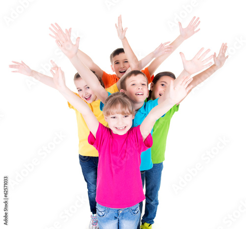 Photo: Group of smiling children with raised hands. Group of smiling children with raised hands.